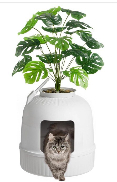 Lifewit hidden plant cat litter box disguised as a white planter with an artificial plant, cat walking out of it